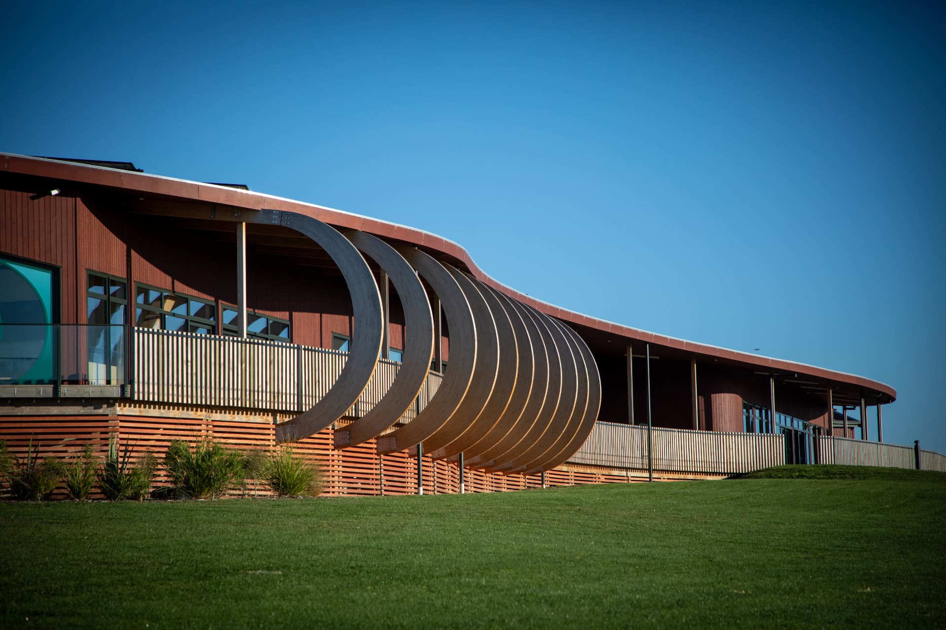 Curved timber arches along the veranda of Murihiku Marae
